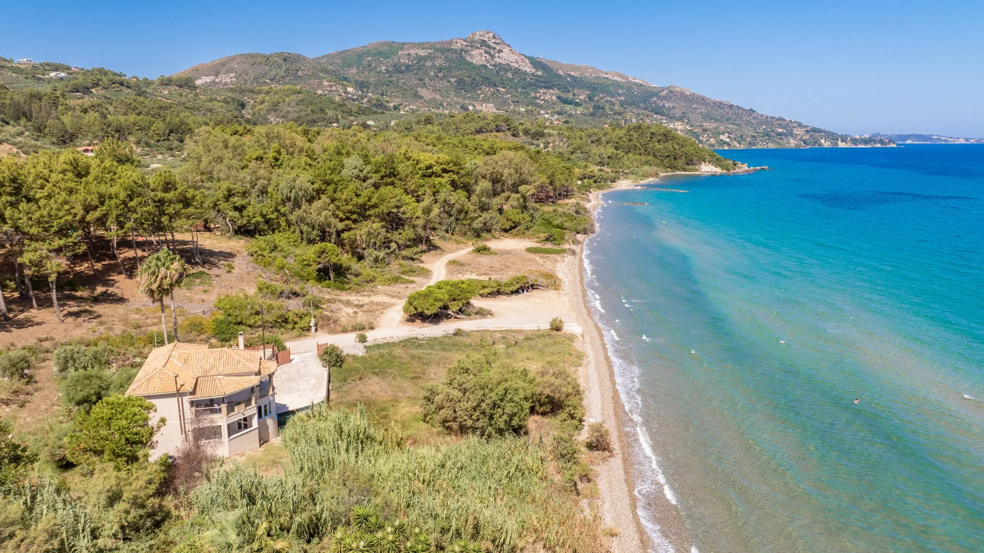 The villa in its green coastal setting